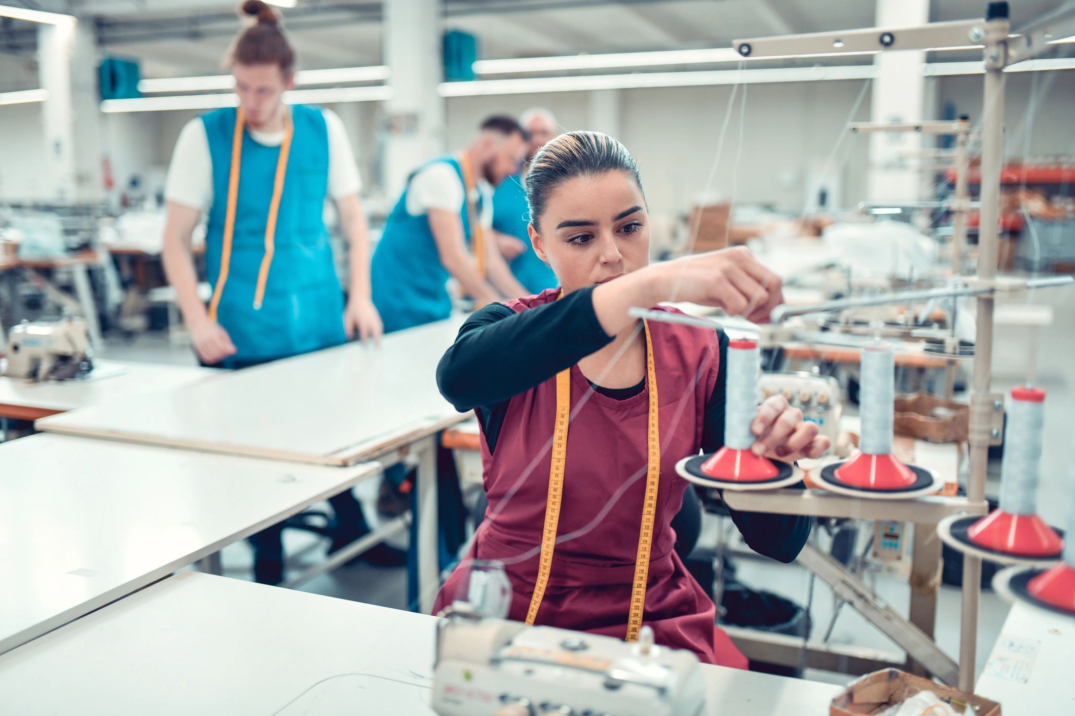 Garment production line with team working on stitching and fabric handling